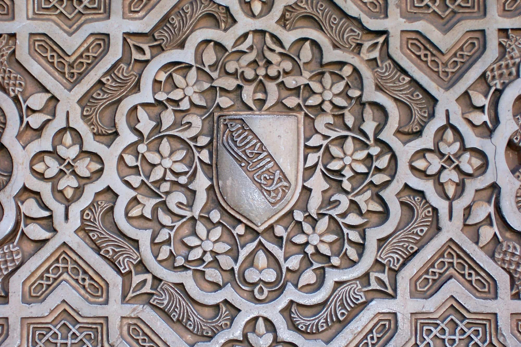  A detail shot of a wall embellished with quatrefoils in The Alhambra, in Granada, Spain.