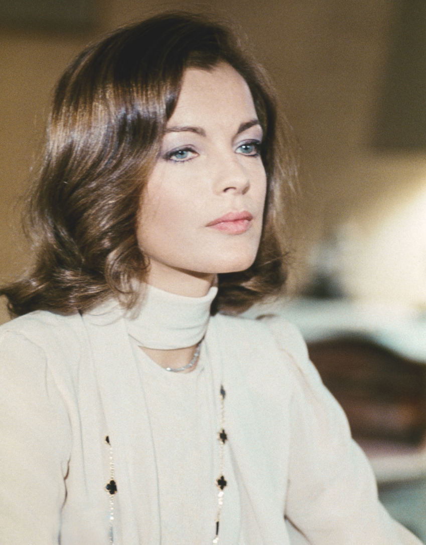 French actress Romy Schneider wearing a Van Cleef & Arpels Alhambra necklace in the 1974 comedy Love at the Top.