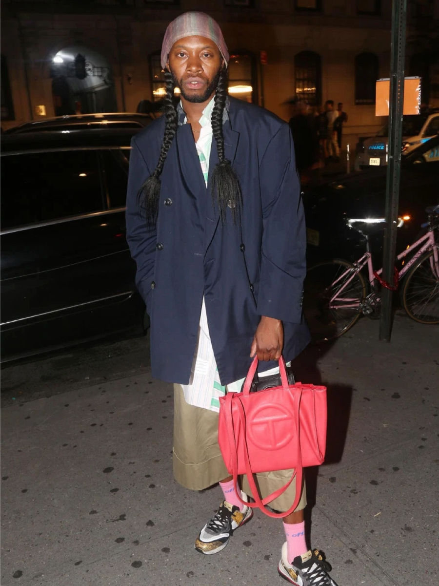 Jeremy O. Harris with a red Telfar bag.