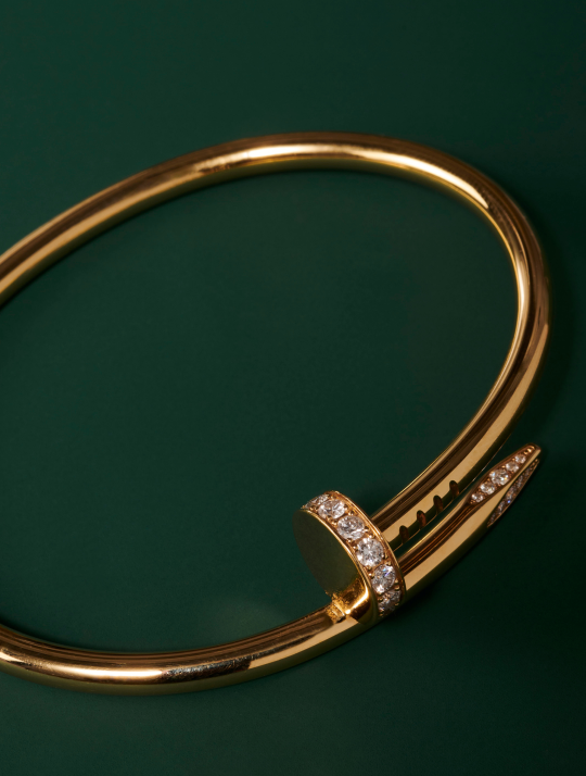 HERO Extreme close-up of a gold Cartier Juste un Clou bracelet with diamonds