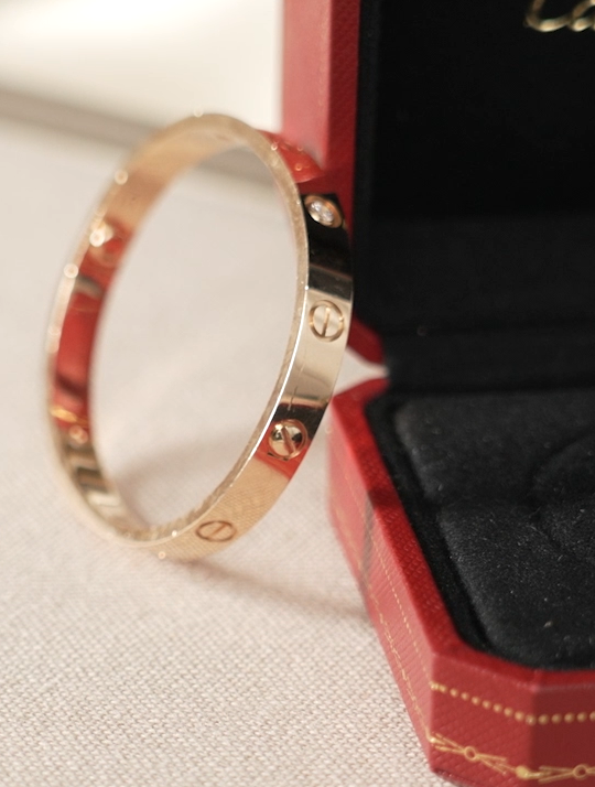 Extreme close-up of a gold Cartier Juste un Clou bracelet with diamonds